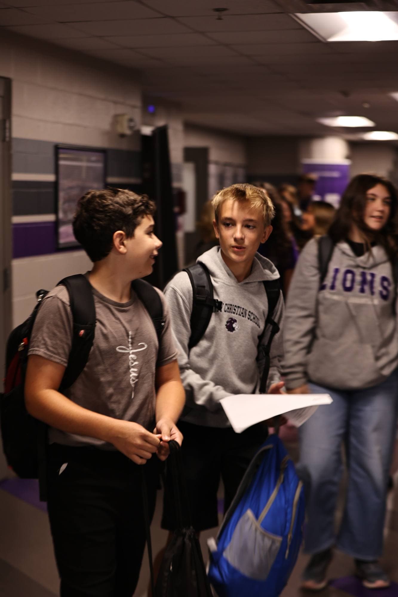 Middle-school TCS students walking together through a school hallway
